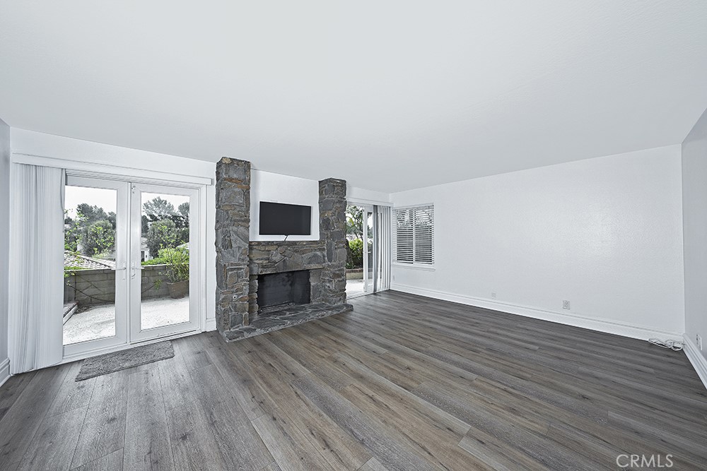 28312 Driza Mission Viejo, CA 92692 - Photo 5 of 21 a view of an empty room with wooden floor fireplace and a window