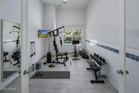 a living room with a table and a book shelf