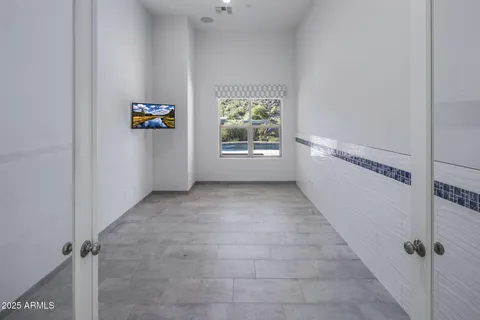 a living room with furniture and a book shelf