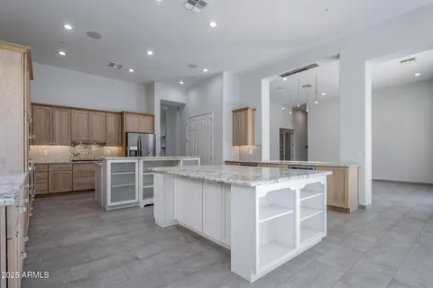 a kitchen with kitchen island cabinets and oven