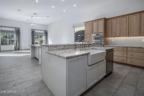 a kitchen with granite countertop cabinets and window