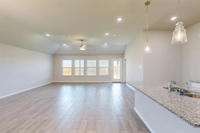 a view of kitchen with stainless steel appliances refrigerator sink and cabinets