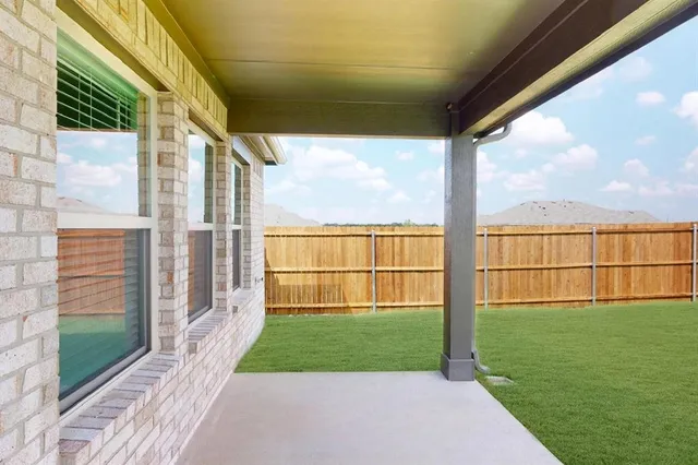 a view of a yard in front of a house with large trees
