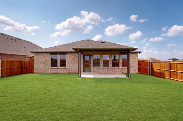 a view of a house with a yard and sitting area