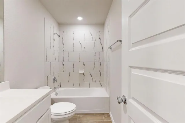 a bathroom with a toilet a sink and bathtub
