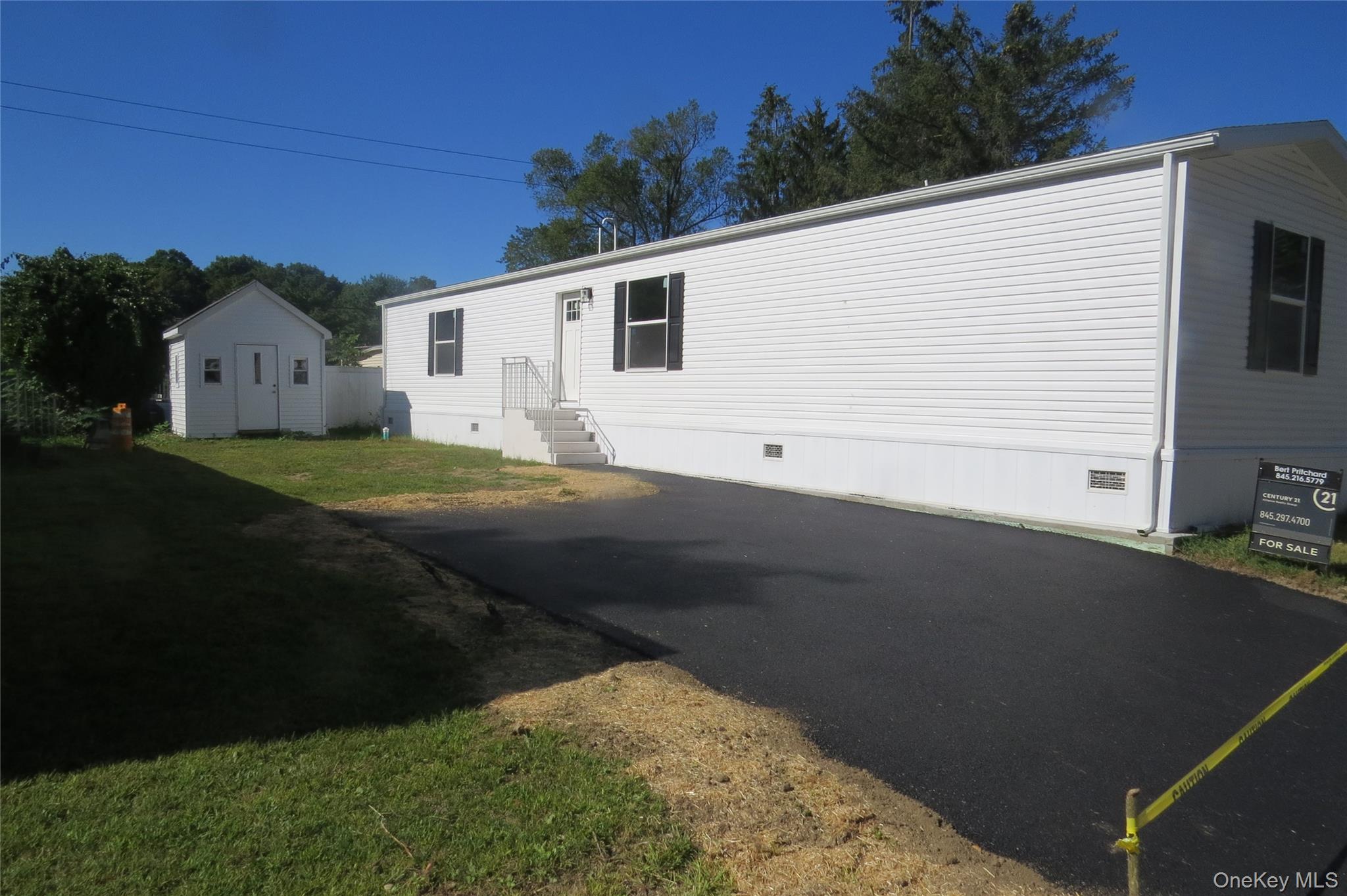 723 Beekman Road, Unit 35 Hopewell Junction, NY 12533 - Photo 1 of 1 Back of property featuring crawl space, a storage shed, and a lawn