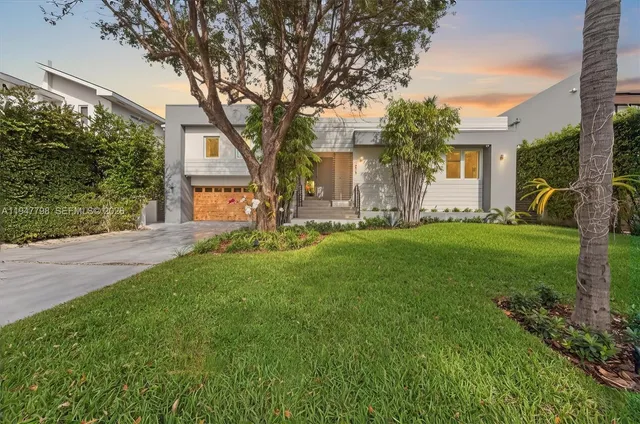 a front view of house with yard and green space