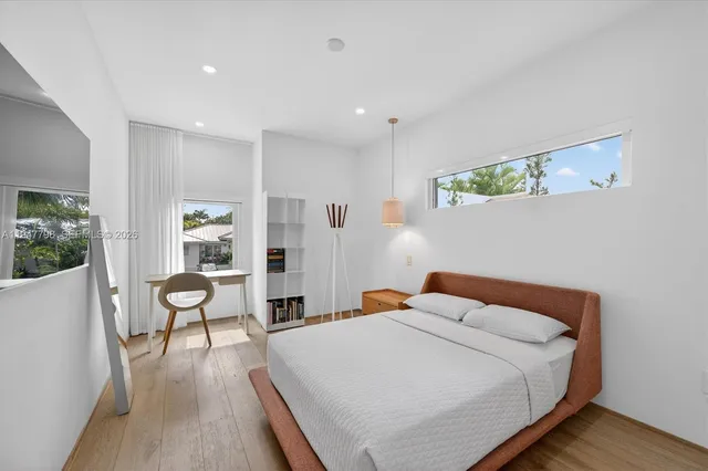 a bed room with a bed and a chair