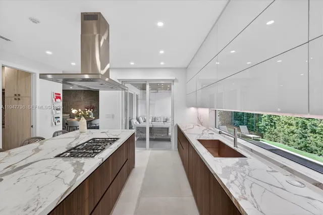 a large kitchen with kitchen island a large counter top