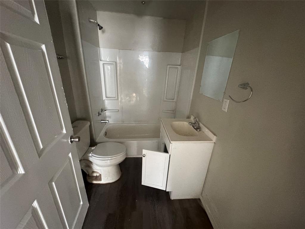 2410 Clinton Street Abilene, TX 79603 - Photo 4 of 7 a bathroom with a sink a toilet and shower