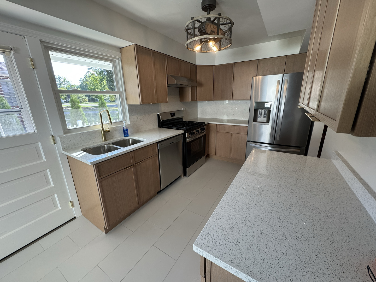 709 West Glencoe Road Palatine, IL 60067 - Photo 6 of 19 a kitchen with stainless steel appliances granite countertop a sink dishwasher stove and refrigerator
