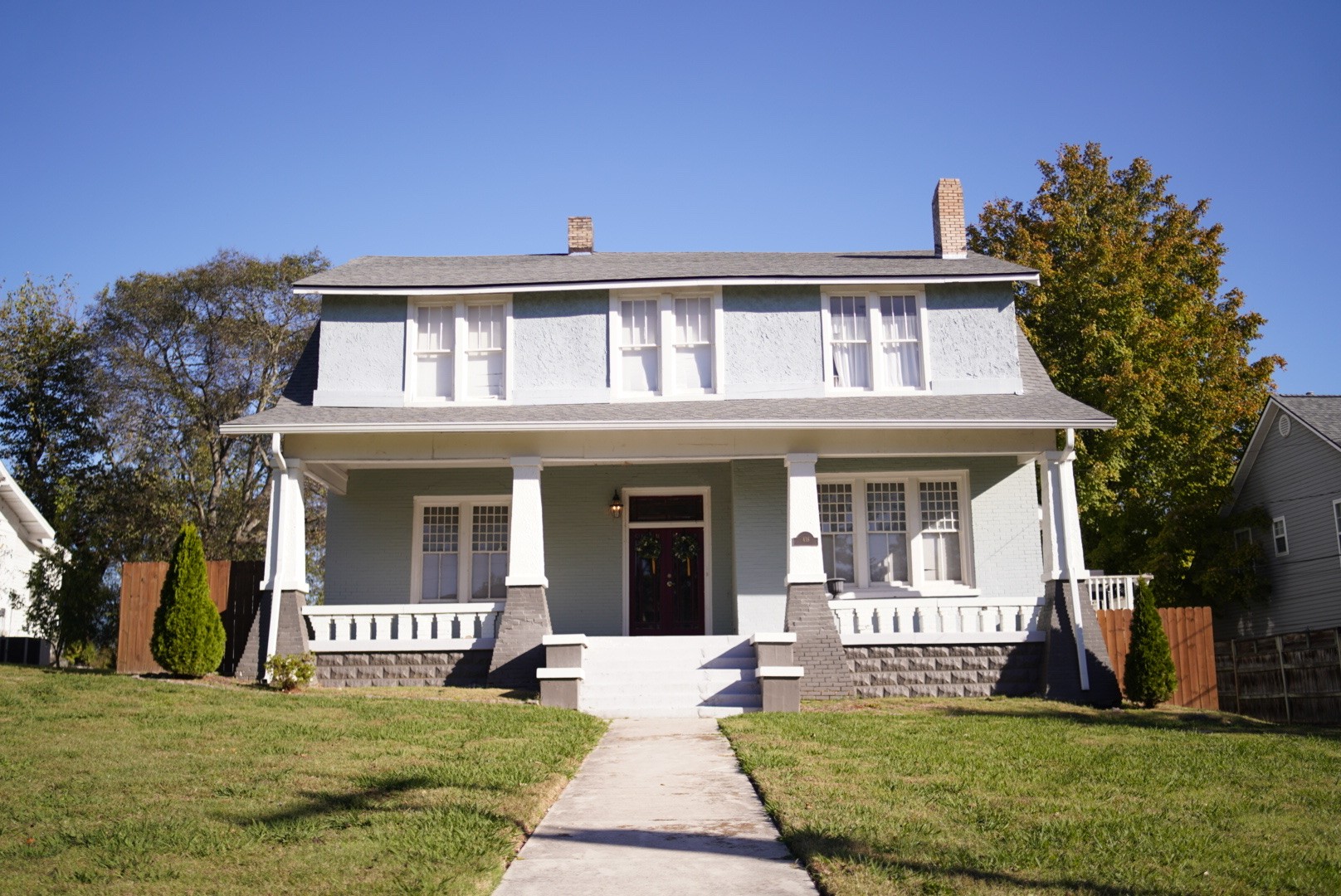 a front view of a house with a garden and yard