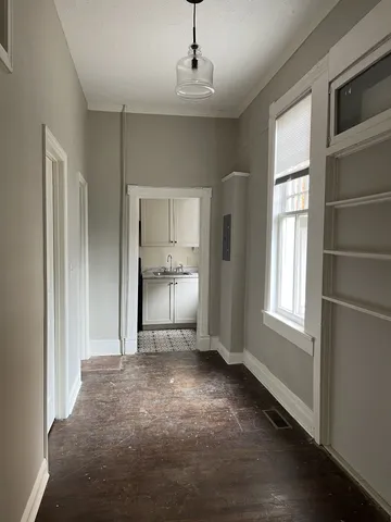 a view of a room with window and wooden floor