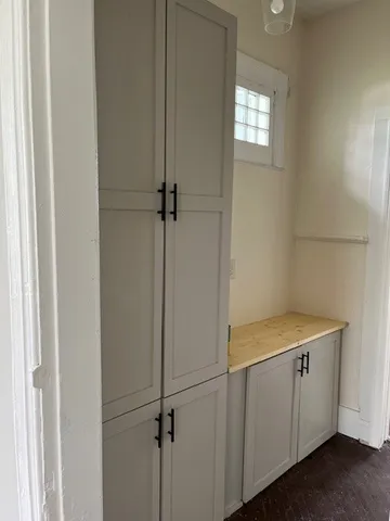 a utility room with cabinets washer and dryer