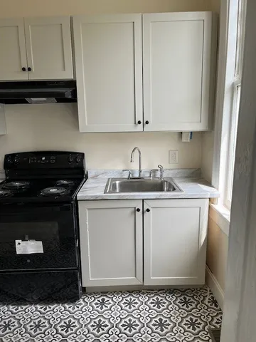 a kitchen with a sink and cabinets