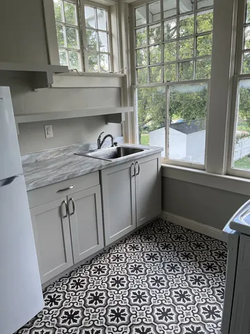 a bathroom with a sink a vanity and a shower
