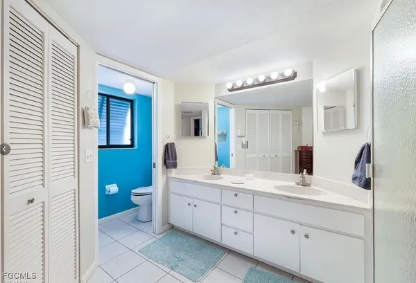 a bedroom with a bed and a chair