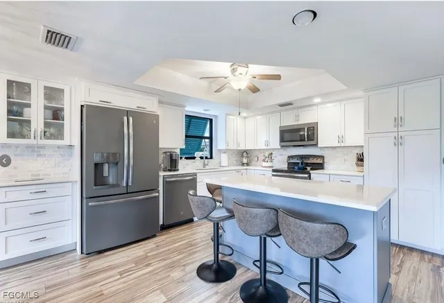 a kitchen with stainless steel appliances a refrigerator stove microwave and cabinets