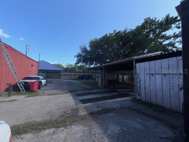644 Maguire Road Ocoee, FL 34761 - Photo 13 of 37 a view of backyard with wooden fence and large trees