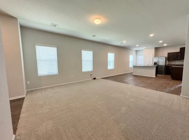 a view of kitchen with refrigerator and window