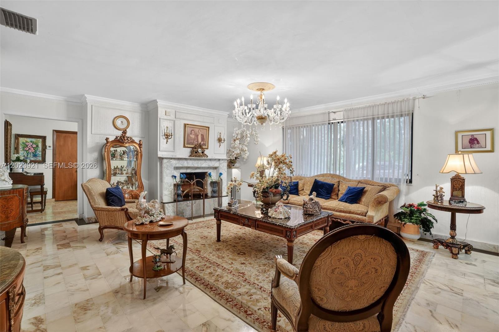 8461 Southwest 68th St Road Miami, FL 33143 - Photo 32 of 65 a living room with furniture a fireplace and potted plants