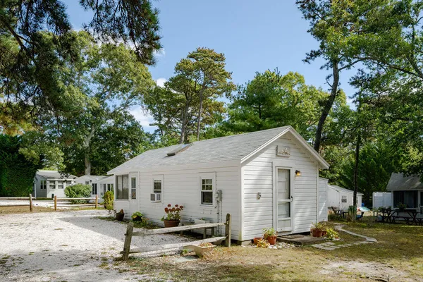 a view of a white house with a yard