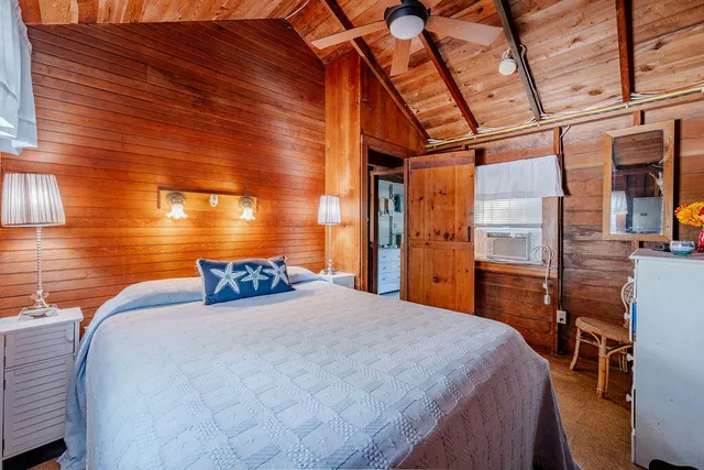 a bedroom with a bed and a table