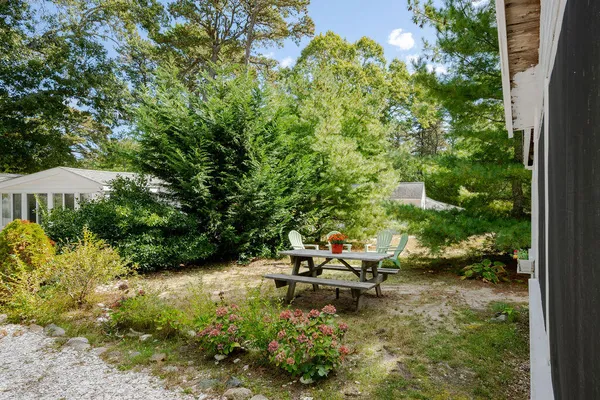a backyard of a house with a yard and outdoor seating