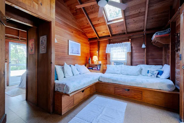 a bedroom with a bed and a mirror