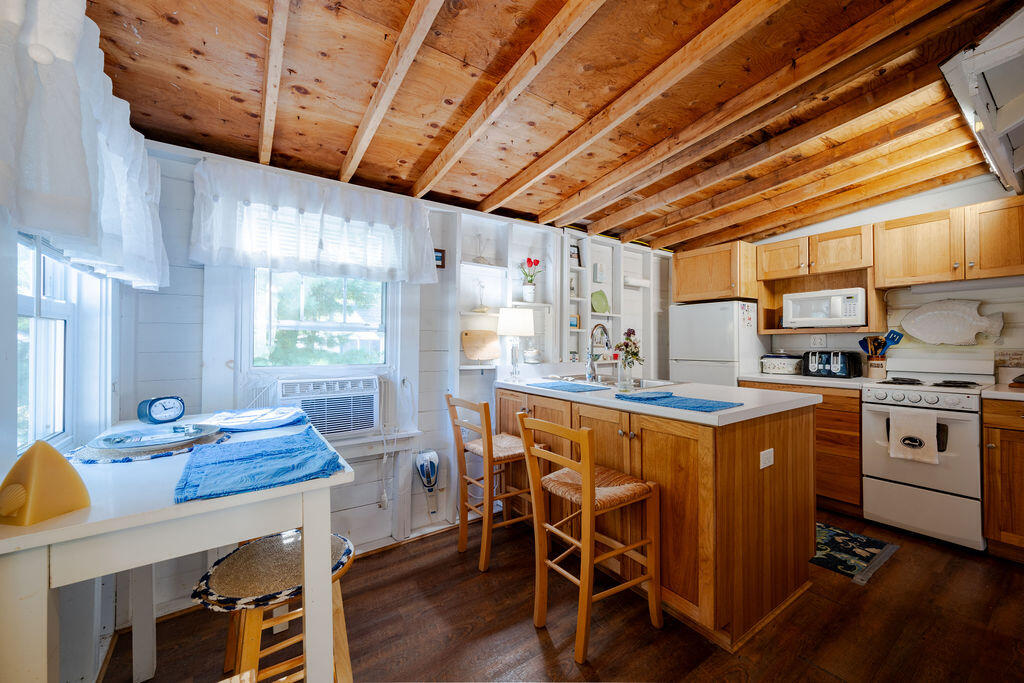 1937 State Highway Route 6, Unit E Eastham, MA 02642 - Photo 8 of 20 a kitchen that has a cabinets counter space a sink and a stove