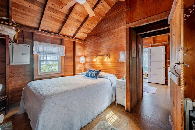 a bedroom with a large bed and a large window