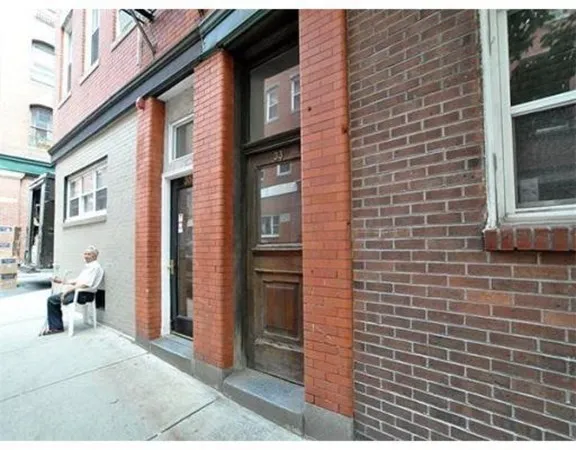 a view of a brick building with many windows