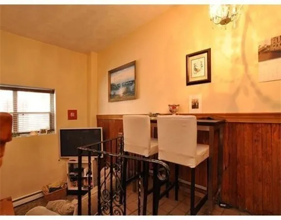 a view of a dining room with furniture and chandelier