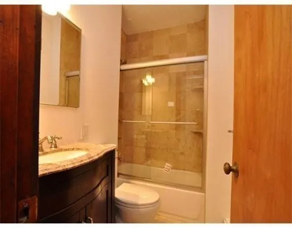 a bathroom with a shower and a sink