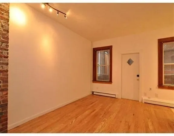 an empty room with a empty space and wooden floor