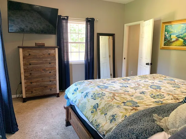 a bedroom with a bed and a flat tv screen