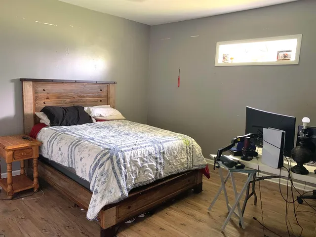 a bedroom with a bed and a window