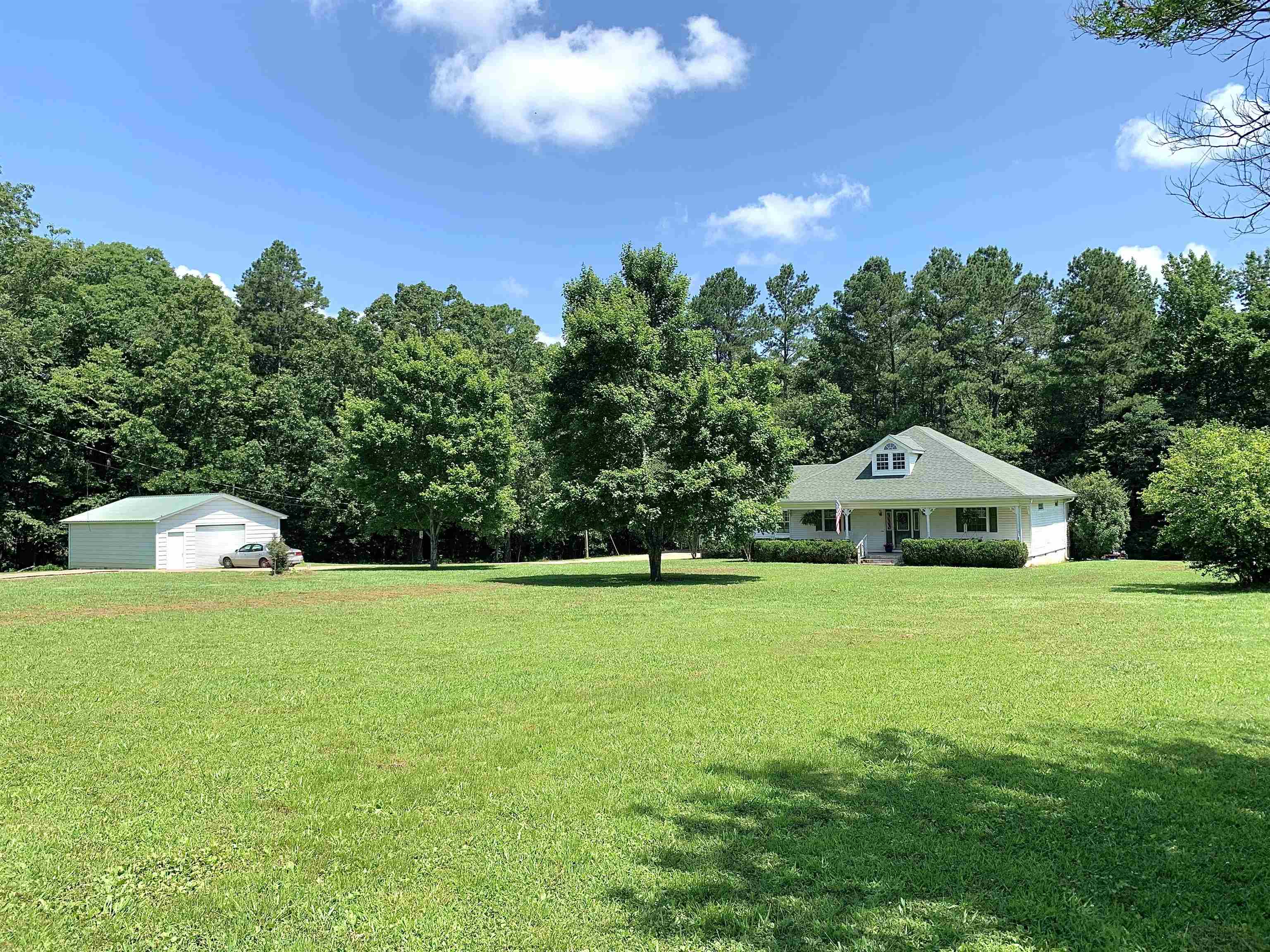 7675 Peavine Road Middleton, TN 38052 - Photo 2 of 26 a front view of a house with a yard and trees