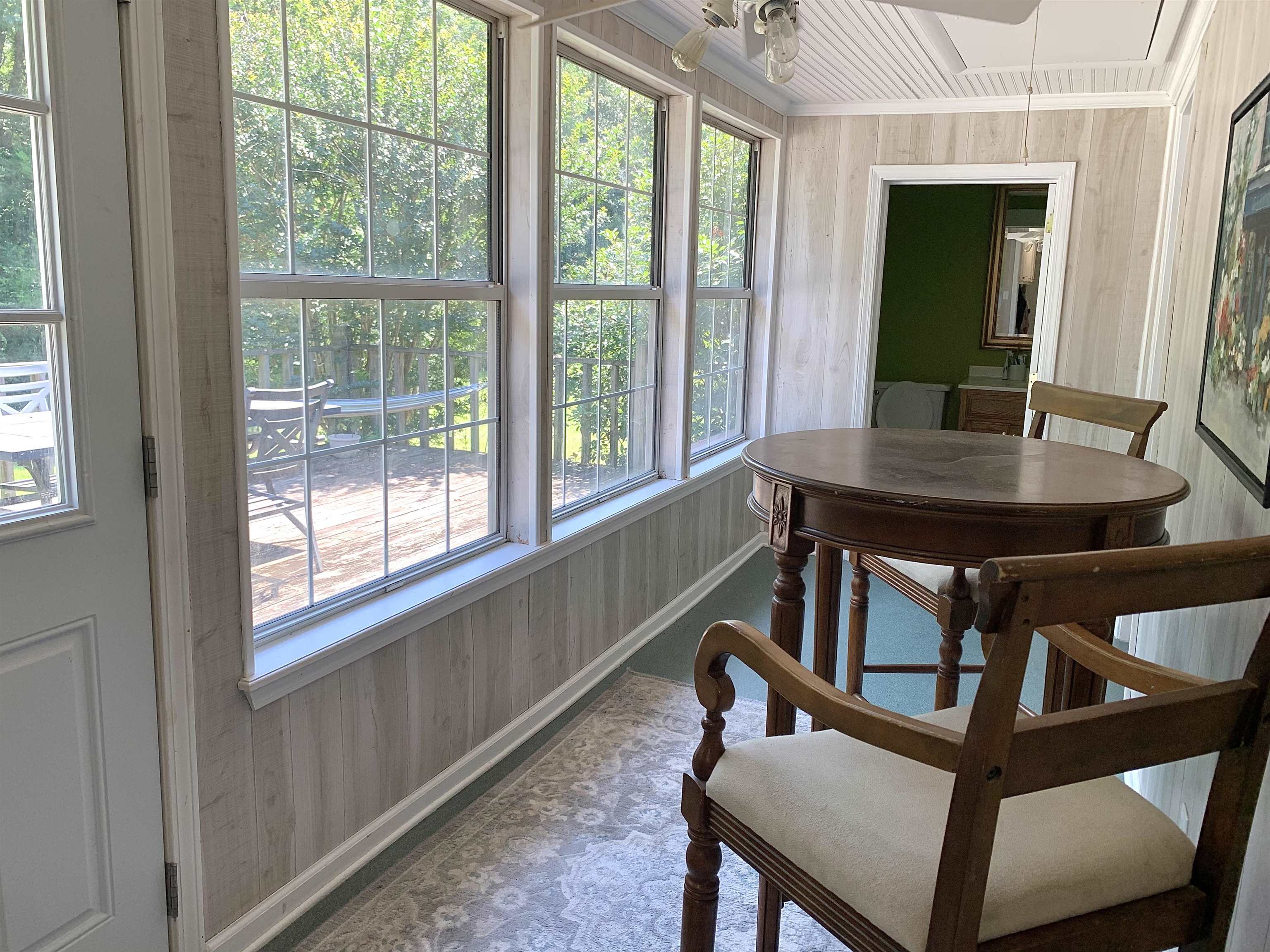 7675 Peavine Road Middleton, TN 38052 - Photo 21 of 26 a view of a dining room with furniture window and wooden floor