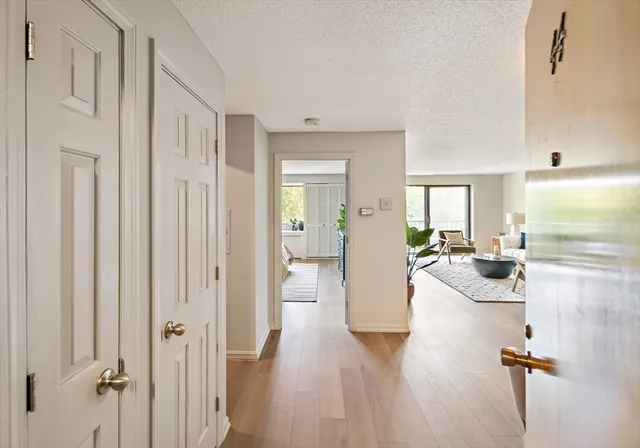 a view of a living room and a livingroom with furniture wooden floor chandelier