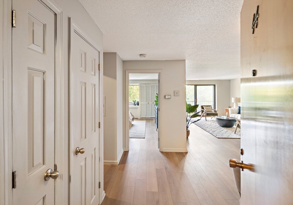 43 Pomeworth Street, Unit 44 Stoneham, MA 02180 - Photo 3 of 15 a view of a living room and a livingroom with furniture wooden floor chandelier
