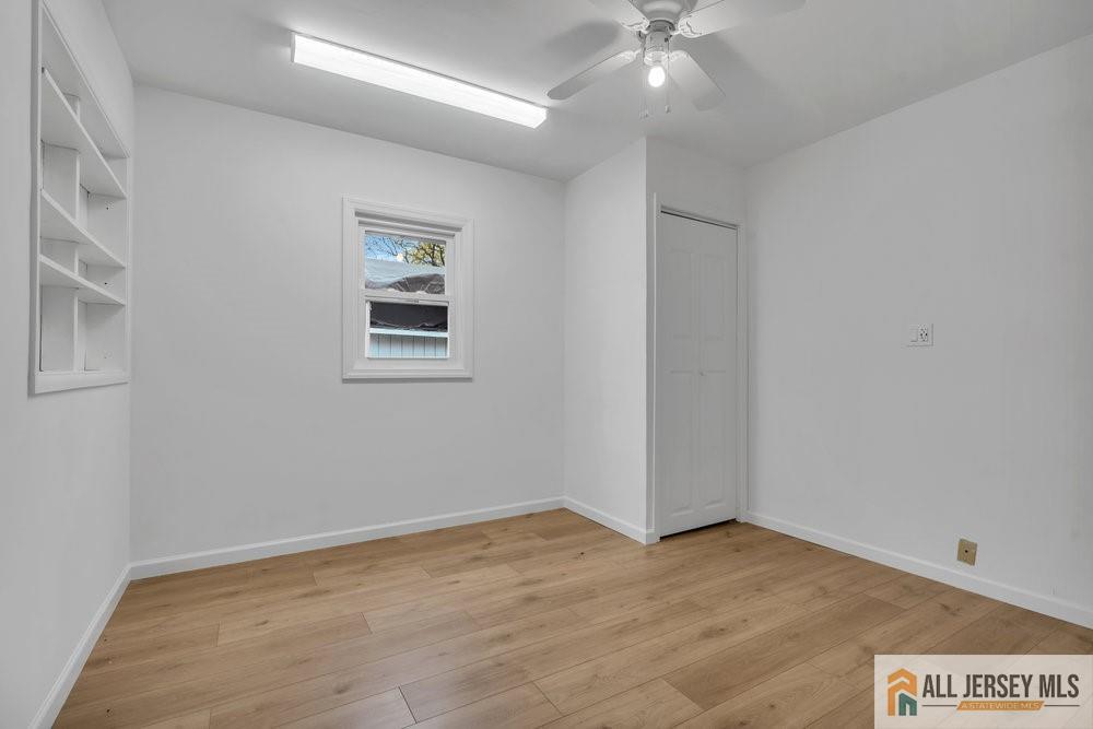36 New Road Kendall Park, NJ 08824 - Photo 13 of 30 wooden floor in an empty room with a window