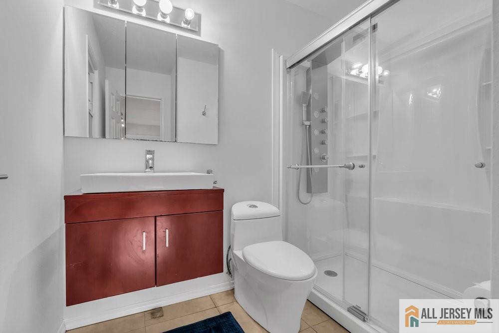 36 New Road Kendall Park, NJ 08824 - Photo 19 of 30 a bathroom with a toilet a sink and shower