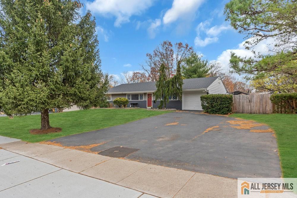 36 New Road Kendall Park, NJ 08824 - Photo 2 of 30 a front view of a house with a yard and a garage