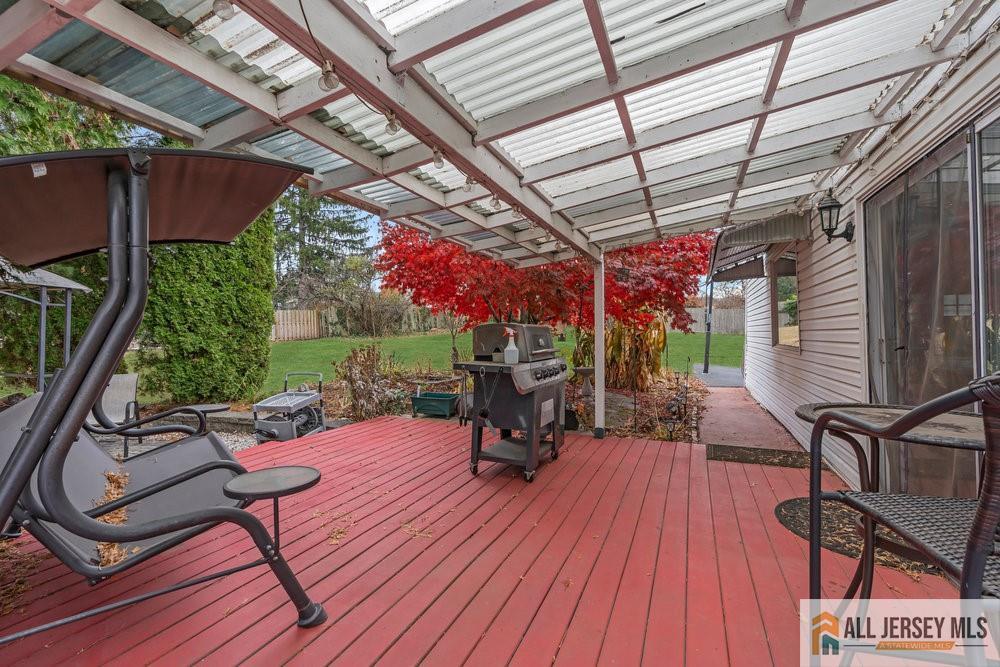 36 New Road Kendall Park, NJ 08824 - Photo 21 of 30 a view of a chairs and table in patio with wooden fence
