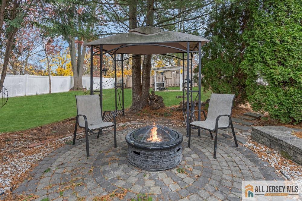 36 New Road Kendall Park, NJ 08824 - Photo 23 of 30 a view of a patio with a table chairs and a backyard