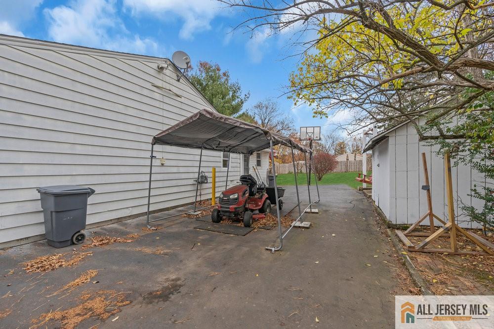 36 New Road Kendall Park, NJ 08824 - Photo 24 of 30 a view of a patio with table and chairs under an umbrella