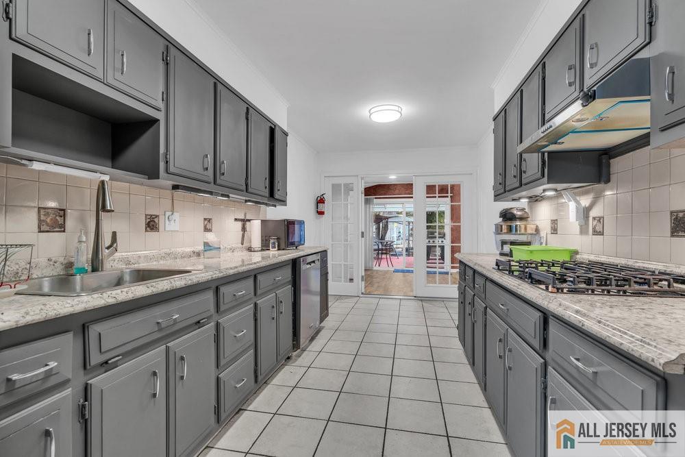 36 New Road Kendall Park, NJ 08824 - Photo 6 of 30 a kitchen with stainless steel appliances granite countertop a stove a sink and a microwave