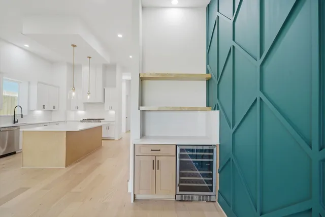 a kitchen with kitchen island a sink stainless steel appliances and cabinets