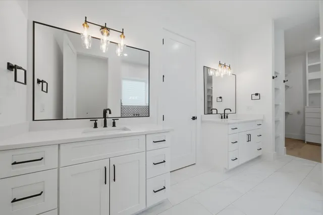 a bathroom with a double vanity sink mirror and double